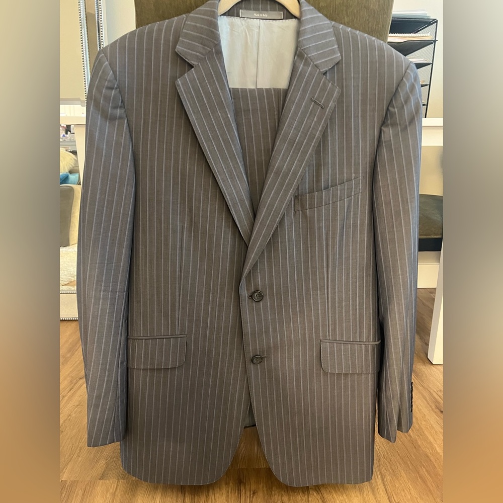 Dunhill brand, grey suit with light blue pinstripes.
